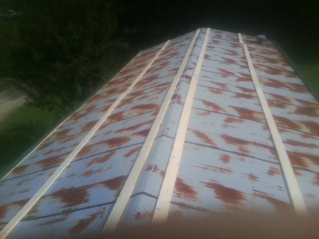 Rusted metal roof panels with new wood purlins before replacement — Storm Damage Roof Repair in Long Eddy by Roofing Brothers