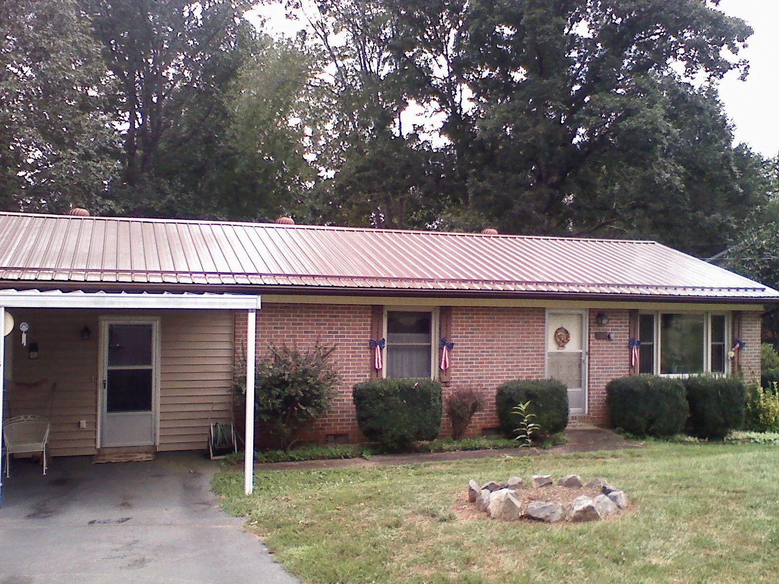 Bronze metal roof and carport on a brick ranch home — Roof Repair work by our crew in Long Eddy