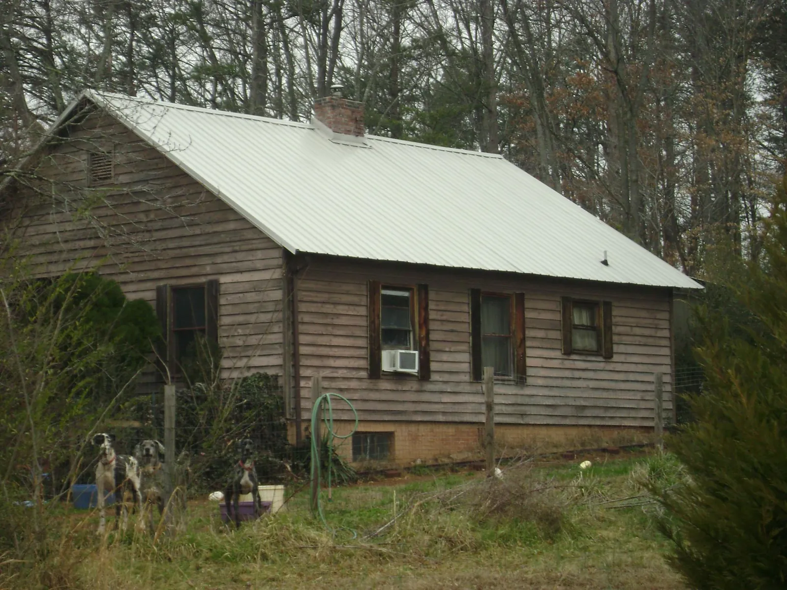 White metal roof on an old wood sided farmhouse, from a Metal Roof Installation job in Long Eddy